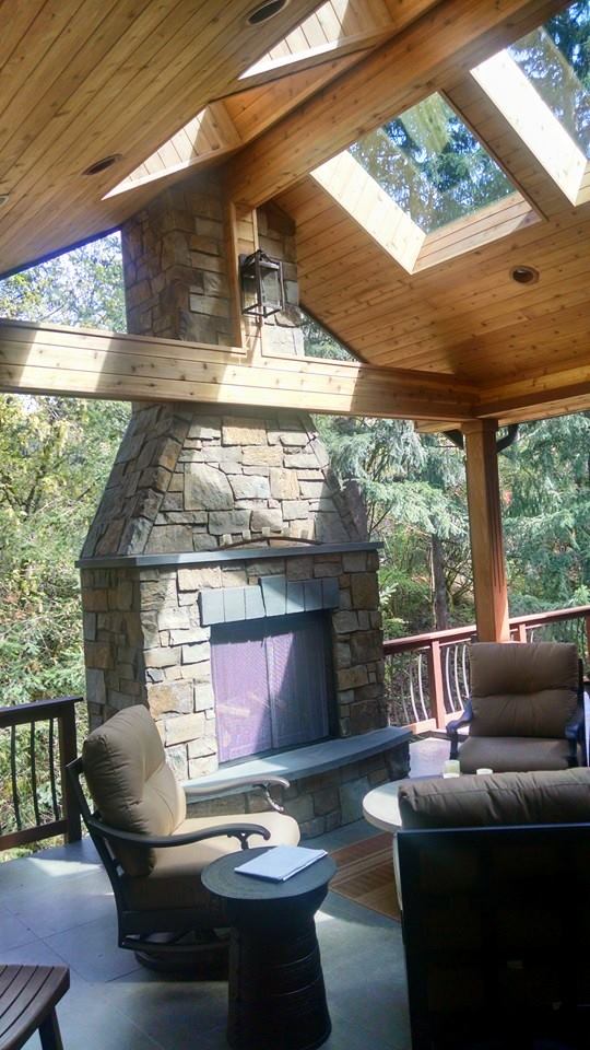 Large outdoor fireplace at the edge of covered deck